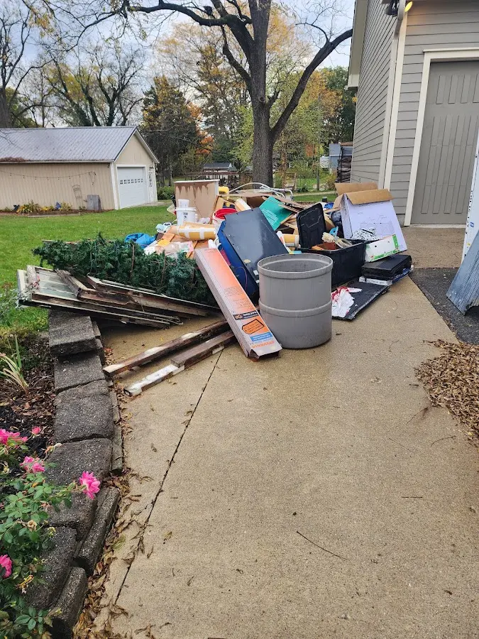 Dumpster being loaded with debris for 12 Yard Dumpster Rental in East Niles